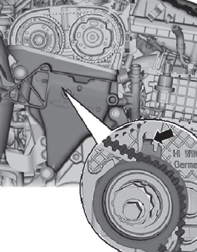 The metal tab (arrow) on the timing belt…