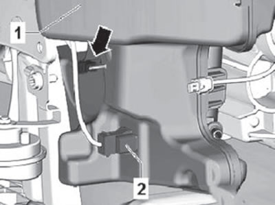 10. Remove the retainer (arrow) of the wiring…