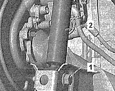 Вывернуть винт «1». Снять амортизатор.