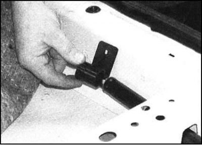 4. Снимите с передней части натяжителя кронштейн…